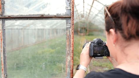 Woman Taking a Photo of a Plants in the Greenhouse · Free Stock Video