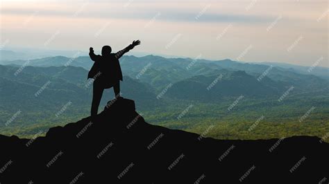 Premium Photo | Silhouette of man on mountain top over sky and sun light