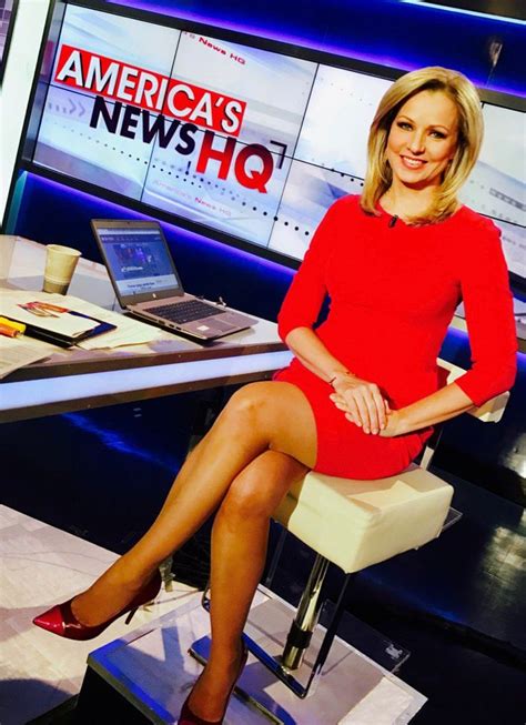 a woman sitting on a chair in front of a news desk