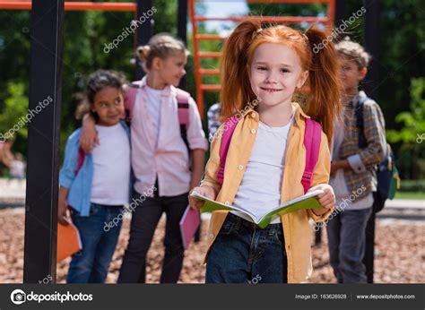 Child with book on playground — Stock Photo © ArturVerkhovetskiy #163626928