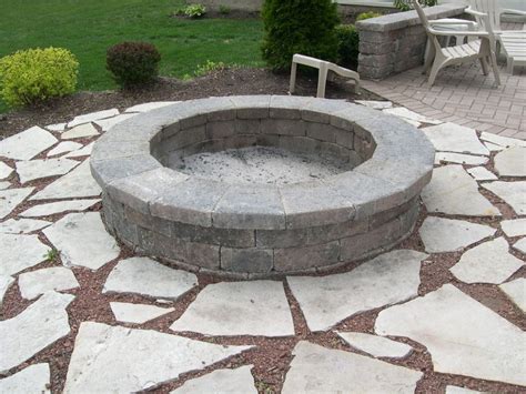 Firepit with smooth stone wall | Fire pit materials, Fire pit, Outdoor fire pit