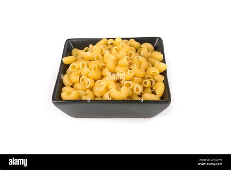 PIle of yellow dried elbow macaroni pasta shapes Stock Photo - Alamy