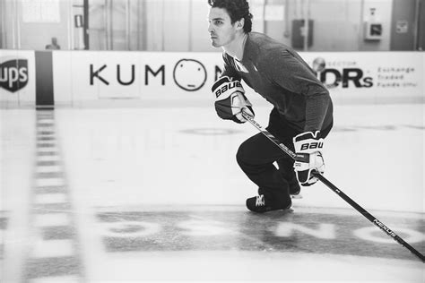 a young man playing ice hockey on an indoor rink