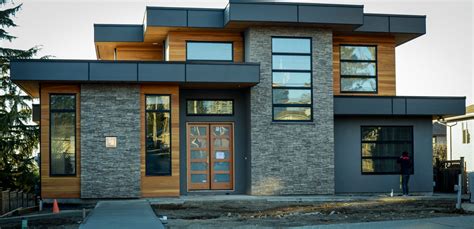 modern home with grey stone and cedar and black trim | Facade house, Modern architecture house ...