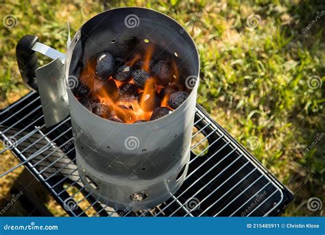 Coal of Charcoal Grill Burning in Flames with Fire and Lighter in Barbecue Chimney for BBQ ...