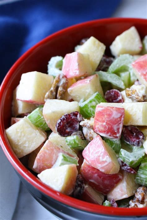 Delicious apple salad in a serving bowl made with Fuji apples, walnuts, celery and cranberries ...