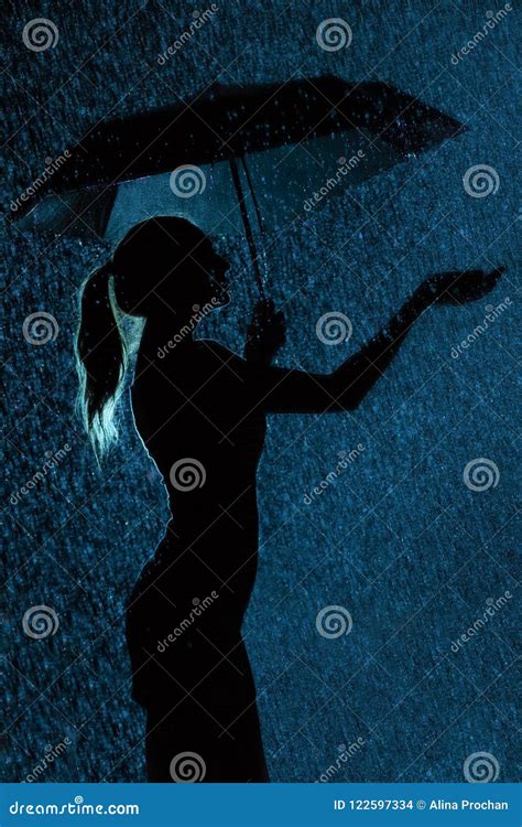 Silhouette of the Figure of a Young Girl with an Umbrella in the Rain Stock Photo - Image of ...