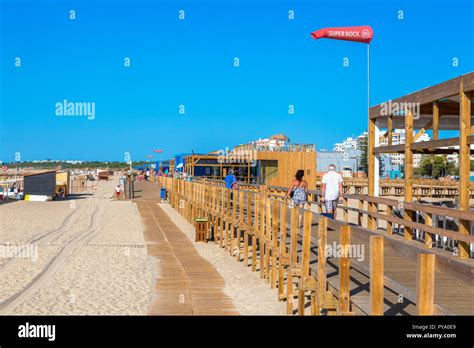 Wooden boardwalk promenade along the beach at Monte Gordo, Algarve ...