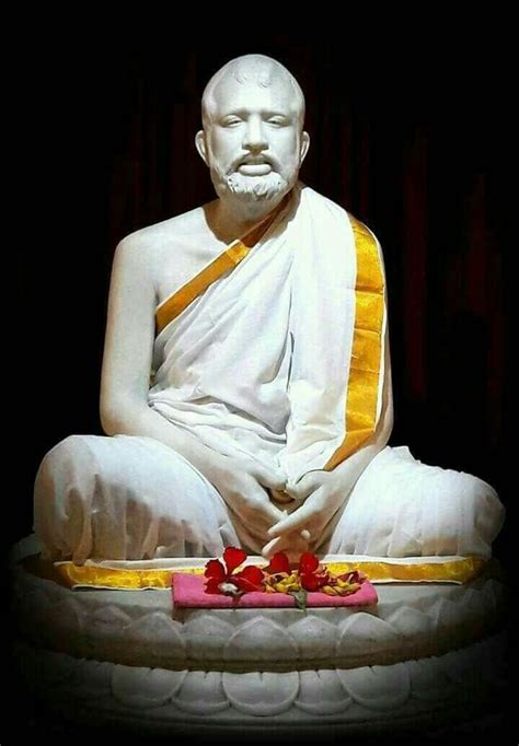 a white buddha statue sitting on top of a table