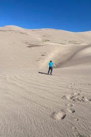 Sandboarding in Colorado (Great Sand Dunes) - Champagne Tastes®