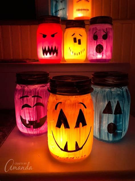 These colorful Halloween luminaries are made from painted mason jars and will light up your ...