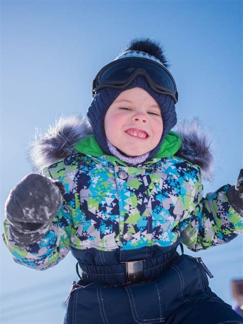 A Small Child Playing in the Winter Park. Playing and Smiling Baby on ...