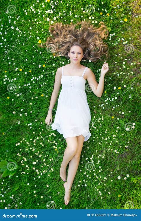 A Young Woman Laying On The Grass In A White Dress Stock Photo - Image: 31466622