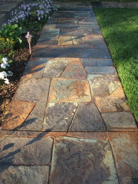 Walkway featuring stamped concrete mimics the look of natural stone ...