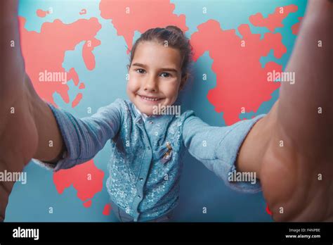 girl teen shouting stretched her arms behind world map education background Stock Photo - Alamy