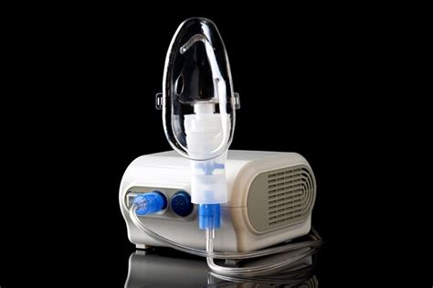 Premium Photo | Electric nebulizer for cough treatment isolated on black background