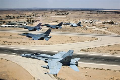 A Jordanian F-16 Fighting Falcon leads another Jordanian F-16, as well as an American F-16, and ...