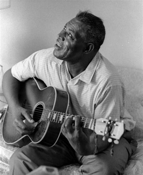 Howlin’ Wolf, posing with his guitar, during an interview for the Chicago Defender, c. 1970s ...