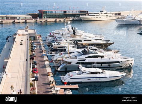 MONTE CARLO, MONACO - OCTOBER 3, 2014: Luxury yachts docked at pier of port Hercule in Monaco ...