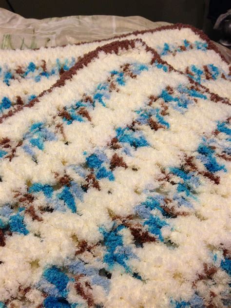 Blanket made with Pipsqueak yarn. Has clusters and is all double crocheted with a single crochet ...