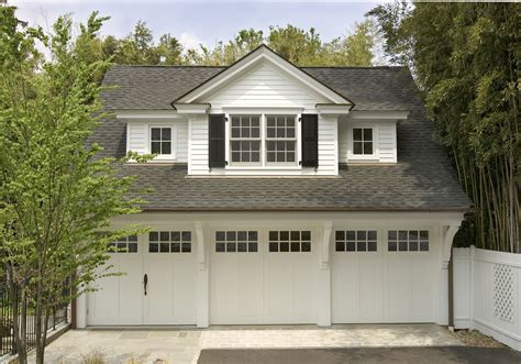 This carriage house with lots of charm and detail has three car bays, a pool changing area and ...