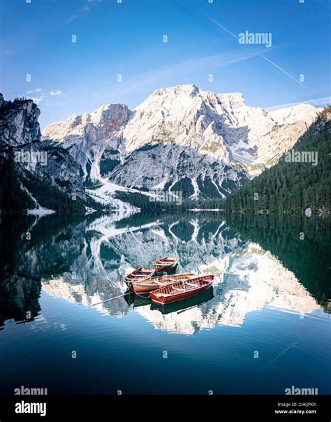 Boats moored in Lake Braies (Pragser Wildsee) with mountains reflected ...