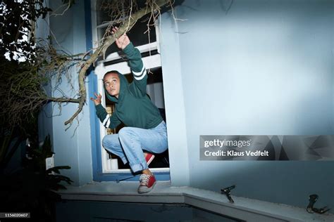 Woman Sneaking Out Of House Window High-Res Stock Photo - Getty Images