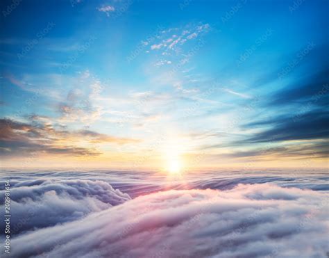 Beautiful sunset sky above clouds Stock Photo | Adobe Stock