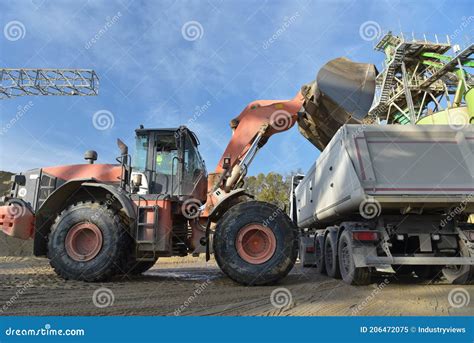 Gravel Pit: Building and Wheel Loader Loading Gravel Onto a Truck Stock ...