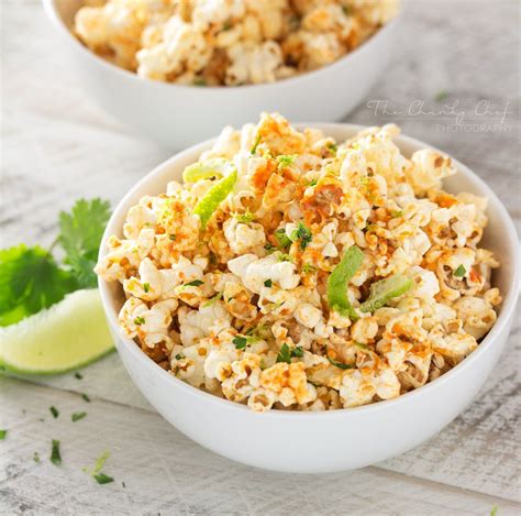 two white bowls filled with popcorn and garnished with cilantro