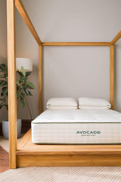 blank avocado mattress on wooden bed frame