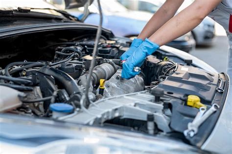 Premium Photo | Experienced female mechanic is servicing a car in her ...