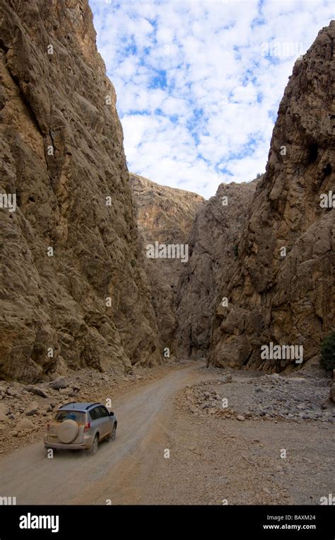 4x4 jeep driving through a canyon, dirt road, mountain landscape, Hajjar mountains, Musandam ...