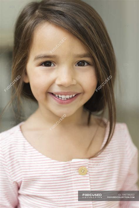 Close up of girls smiling face — childhood, vertical - Stock Photo | #199739202