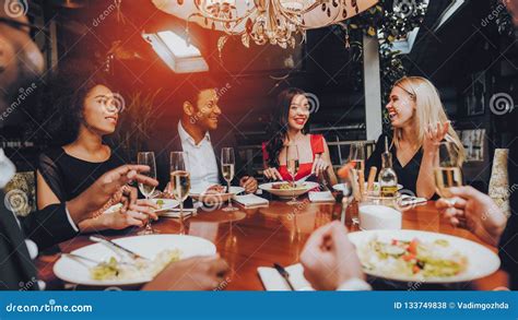 Group of Happy Friends Meeting and Having Dinner Stock Photo - Image of ...