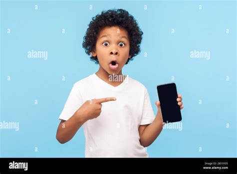 Wow awesome mobile app. Amazed excited cute little boy pointing at cell ...