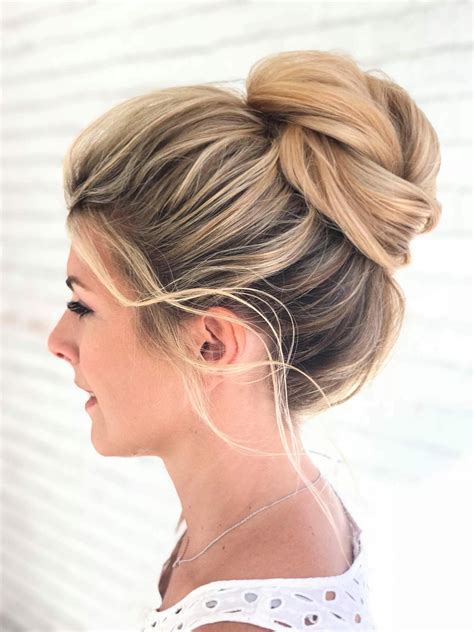 Messy high bun on blonde highlighted hair, gorgeous for a wedding updo #ombreweddinghair ...