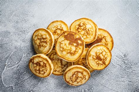 Premium Photo | Stack of buttered pancakes on a kitchen table. white background. top view.
