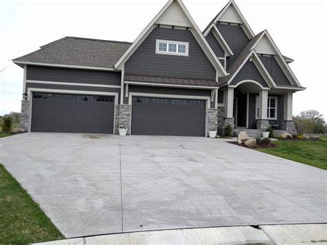 Dark Grey siding and dark garage doors. Nice Stone accents. | Grey ...