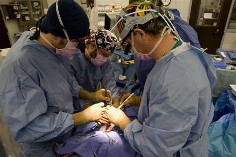 Dr. Robert Jaquiss (right) performs heart-transplant surgery on Christopher Schroeder ...