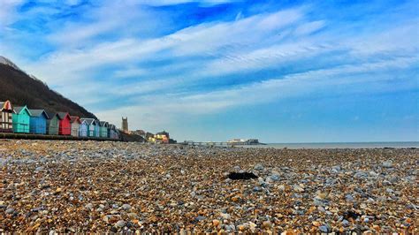 Cromer beach, huts, pier & spacious sky | Beach, Natural landmarks, Outdoor