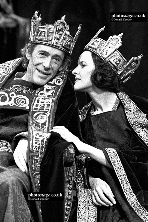 a man and woman wearing crowns sitting next to each other in black and white photo