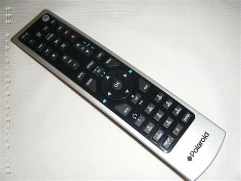 a remote control sitting on top of a white sheeted tablecloth with the word monopoly written on it