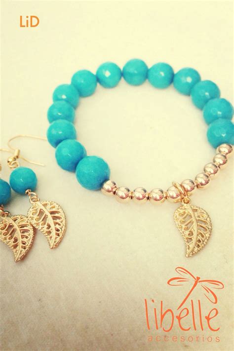 a bracelet with two charms and a leaf charm