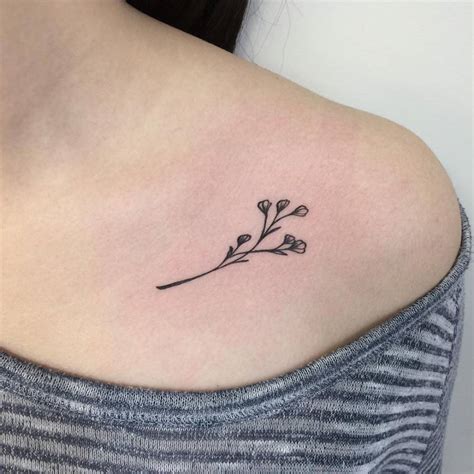 Dry flower tattoo on the left side collarbone.