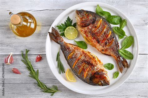 roasted sea bream fish with lemon slices Stock Photo | Adobe Stock