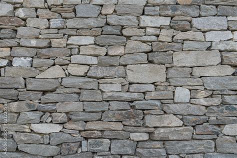 Stone wall texture background - grey stone siding with different sized ...