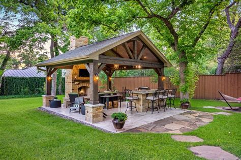 This freestanding covered patio with an outdoor kitchen and fireplace ...