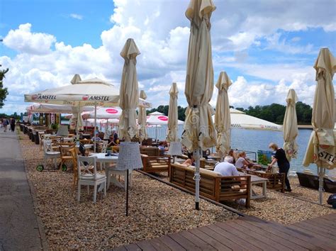 : People Relaxing on the Alleys with Restaurants of a Park Near Ada Ciganlija Lake, Serbia ...