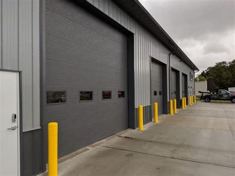 Industrial Building with Yellow Poles and Garage Doors